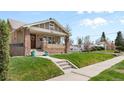 Inviting home exterior featuring a covered porch, brick accents, and steps leading to the front door at 2900 Clermont St, Denver, CO 80207