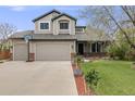 Charming two-story home featuring a two-car garage, well-manicured lawn, and beautiful curb appeal at 17522 E Dewberry Dr, Parker, CO 80134