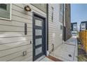 Modern townhome entrance with a stylish black front door and visible house number at 1284 Stuart St, Denver, CO 80204