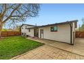 Spacious backyard featuring a large grassy area and patio, perfect for outdoor entertaining and relaxation at 1430 Lashley St, Longmont, CO 80504