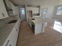 Well-lit kitchen with white cabinets, a center island with a sink, and stainless steel appliances at 5685 Farrier Pt, Castle Rock, CO 80104