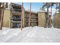 Exterior of condo building featuring balconies and snow-covered walkway and surroundings at 1173 Ski Hill Rd # 127, Breckenridge, CO 80424