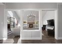 Beautifully designed living room with vaulted ceilings, fireplace and mantle, and comfortable seating arrangement at 7863 Windfont Row, Parker, CO 80134