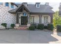 The front porch features brick accents, dark trim, an entry door, and seating area at 618 Fairchild Dr, Highlands Ranch, CO 80126