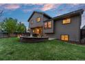 Spacious backyard features a fire pit, patio, and ample green space for outdoor enjoyment at 12017 W Cross Dr, Littleton, CO 80127