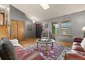 Inviting living room with hardwood floors, vaulted ceiling, and natural light from large windows at 12017 W Cross Dr, Littleton, CO 80127