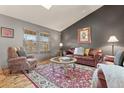 Cozy living room with hardwood floors, a neutral color palette, and comfortable seating at 12017 W Cross Dr, Littleton, CO 80127