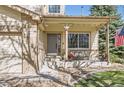 Cozy front porch with bench seating, decorative plants, and an American flag, offering a welcoming entrance to the home at 3805 E 106Th Ave, Thornton, CO 80233