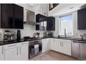 Modern kitchen boasts sleek black and white cabinets, stainless steel appliances, and lots of light at 790 N Clarkson St # 206, Denver, CO 80218
