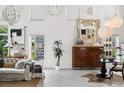 Minimalist living area featuring white walls, artistic decor, seating, and lots of natural light at 790 N Clarkson St # 206, Denver, CO 80218