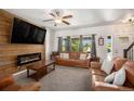Bright living room with a cozy fireplace and comfortable leather seating at 5475 Shoshone Dr, Longmont, CO 80504