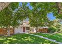 Beautiful home featuring a lush green lawn, mature trees, and a charming red front door at 2896 W 119Th Ave, Westminster, CO 80234