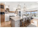 Spacious kitchen with a large island, modern pendant lighting, and stainless steel appliances at 7033 E Lake Cir, Centennial, CO 80111
