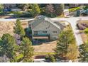 Beautiful modern home featuring large windows, a deck, professional landscaping and mature trees at 7778 Windwood Way, Parker, CO 80134