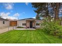 Inviting single-story home featuring a well-maintained lawn and charming facade at 109 S Fulton Ave, Fort Lupton, CO 80621