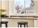 Cozy breakfast nook featuring a window and bar stools, perfect for morning coffee or snacks at 6880 W Airview Ave, Lakewood, CO 80232