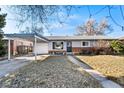 Lovely single-story home with a covered carport and tidy front yard, perfect for suburban living at 6880 W Airview Ave, Lakewood, CO 80232