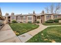 View of condo complex showing lawn and walkway to building entrance at 2670 E Otero Pl # 11, Centennial, CO 80122