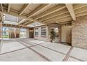 View of covered entryway with brick columns, stairs and a unit entry door at 2670 E Otero Pl # 11, Centennial, CO 80122