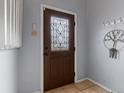 Inviting entryway with a decorative glass front door, tiled flooring and a coat rack for added convenience at 416 Pluto Ct, Lone Tree, CO 80124