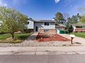 Charming two-story home with solar panels, attached garage, and low-maintenance front yard at 416 Pluto Ct, Lone Tree, CO 80124