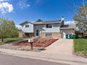 Charming two-story home with solar panels, attached garage, and low-maintenance front yard at 416 Pluto Ct, Lone Tree, CO 80124