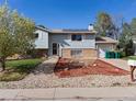 Charming two-story home with solar panels, attached garage, and low-maintenance front yard at 416 Pluto Ct, Lone Tree, CO 80124