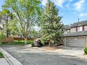 Townhome on a tree-lined street featuring an attached two-car garage at 3529 S Telluride Cir # D, Aurora, CO 80013