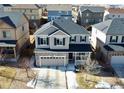 Aerial view of a well maintained two-story home with neutral siding and a stone facade in a Gathering neighborhood at 25206 E Lake Dr, Aurora, CO 80016