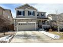 Inviting two-story home showcasing a stone facade, neutral siding, a two car garage and a well-maintained driveway at 25206 E Lake Dr, Aurora, CO 80016