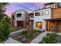 Modern home showcasing clean lines, mixed materials, and a well-manicured front yard with vibrant landscaping at 2248 S Lincoln St, Denver, CO 80210