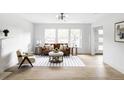 Elegant living room with hardwood floors, large windows, and stylish furniture at 3930 S Hillcrest Dr, Denver, CO 80237