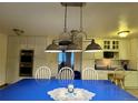 Bright dining area with a table, chairs, and view into the kitchen at 22400 County Road 10, Hudson, CO 80642