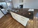 Close up of the kitchen island with granite countertops and stainless steel sink at 1927 Rannoch Dr, Longmont, CO 80504