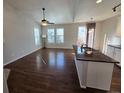 Open-concept living space with hardwood floors, modern lighting, and large windows for natural light at 1927 Rannoch Dr, Longmont, CO 80504