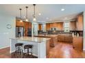 Spacious kitchen with two islands, stainless steel appliances, and wood cabinets at 2272 Front Range Rd, Erie, CO 80516