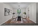 Bright dining room with a glass table, modern light fixture, and hardwood floors at 6240 W 110Th Pl, Westminster, CO 80020