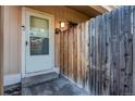 Close-up of a townhome front door and fence, creating a sense of privacy and security at 8798 Chase Dr # 2, Arvada, CO 80003
