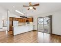 Bright kitchen with wood cabinets, hardwood floors, and breakfast bar at 9748 W Peakview Dr, Littleton, CO 80123