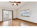 Spacious living room featuring hardwood floors and sliding doors to deck at 9748 W Peakview Dr, Littleton, CO 80123