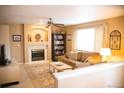 Inviting living room with fireplace, built-in shelving, neutral color palette, and comfortable seating at 9926 Apollo Bay Way, Highlands Ranch, CO 80130