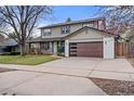 Attractive home features a modern garage door, covered porch, and well-manicured lawn at 4102 W Union Ave, Denver, CO 80236