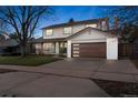 Beautiful home features a modern garage door, covered porch, and well-manicured lawn at 4102 W Union Ave, Denver, CO 80236