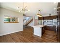 Spacious open kitchen and dining area with modern lighting, stainless appliances, and center island at 4258 Tennyson St # 101, Denver, CO 80212