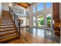 Open-concept living space with high ceilings, a modern staircase, and a fireplace at 4258 Tennyson St # 101, Denver, CO 80212