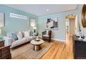 Inviting living room with a light-filled atmosphere, neutral tones, and hardwood floors at 4844 Vallejo St, Denver, CO 80221