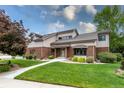 Well-maintained home featuring a brick facade, manicured lawn and inviting front entrance at 8160 W Phillips Ave, Littleton, CO 80128