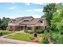 Beautifully landscaped front yard complements this home's inviting exterior at 8160 W Phillips W Ave, Littleton, CO 80128