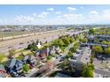 Neighborhood aerial view, showing proximity to highway and Denver city in the distance at 10778 Dayton Way, Commerce City, CO 80640