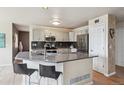 Modern kitchen features a center island, sleek stainless steel appliances, and stylish cabinets at 5986 Dunraven Ct, Golden, CO 80403